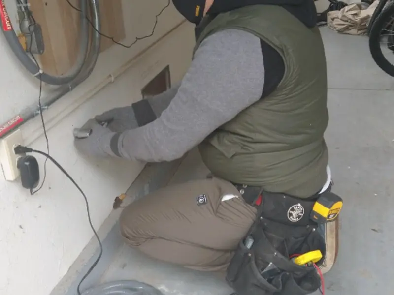 Electrician performing outlet wiring in a Euharlee garage